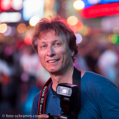 Portrait of photographer Norbert Schramm with his Canon action photography equipment